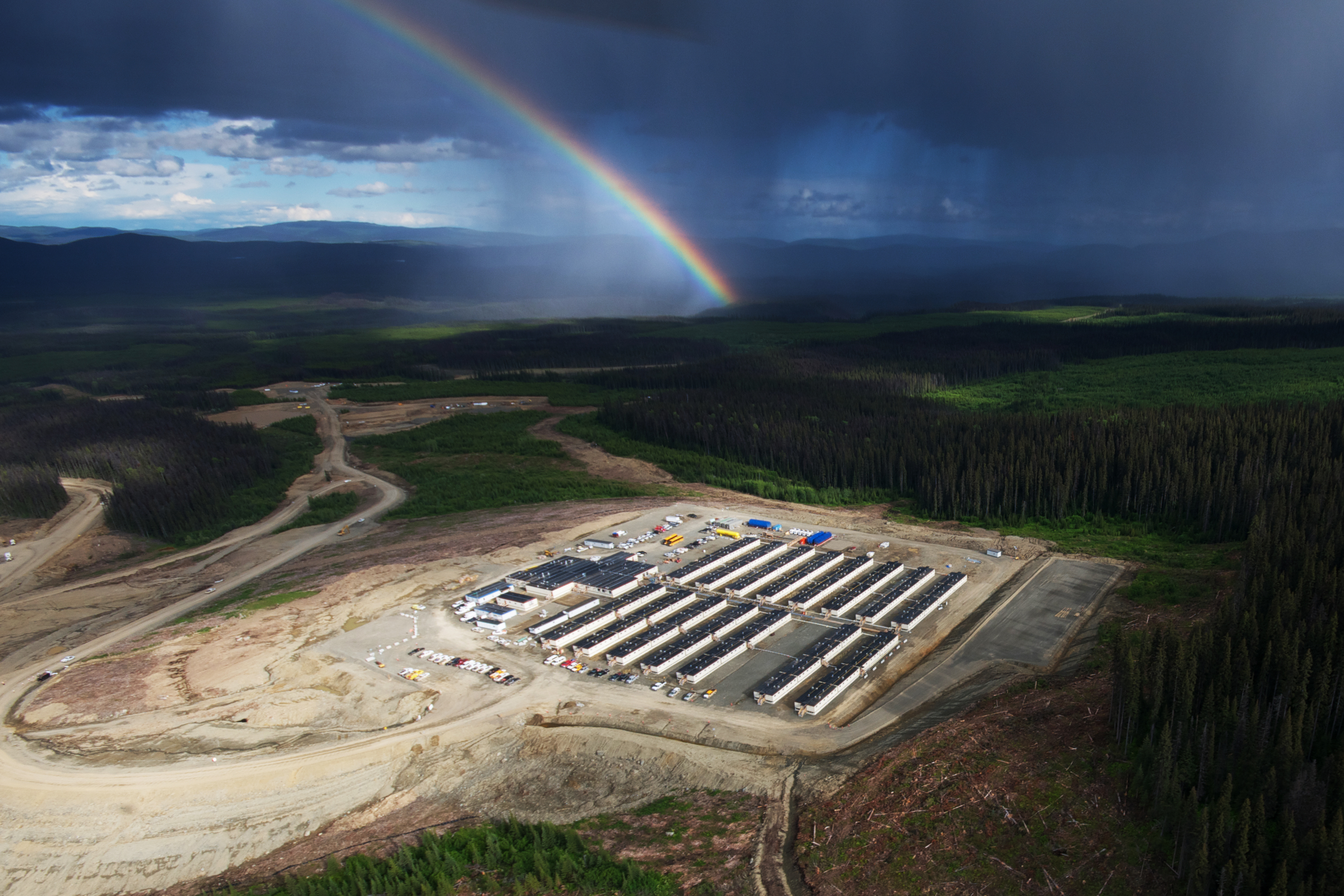 Remote industrial camp with rainbow overhead, representing workforce lodging in isolated project locations
