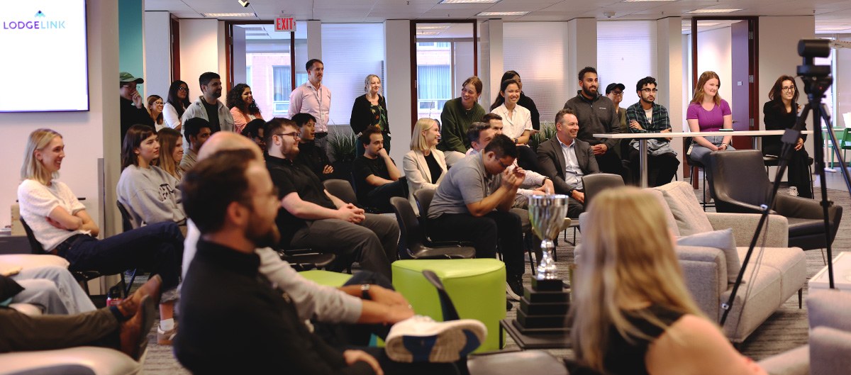 The audience attentively watches a presentation in a modern conference room.