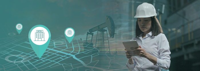 A woman in a hard hat using a tablet, with location markers and an oil rig in the background, representing workforce travel.