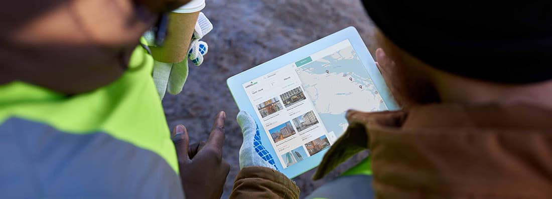 A close-up of a group of people looking at a map on a workforce travel site