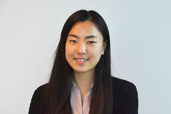 Professional headshot of LodgeLink team member with long dark hair, smiling against light background.