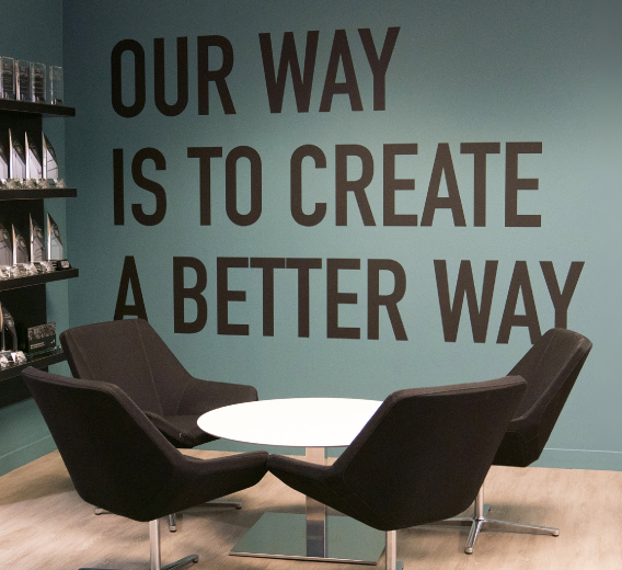 A room with chairs and a table and Black Diamond Group's mission statement.