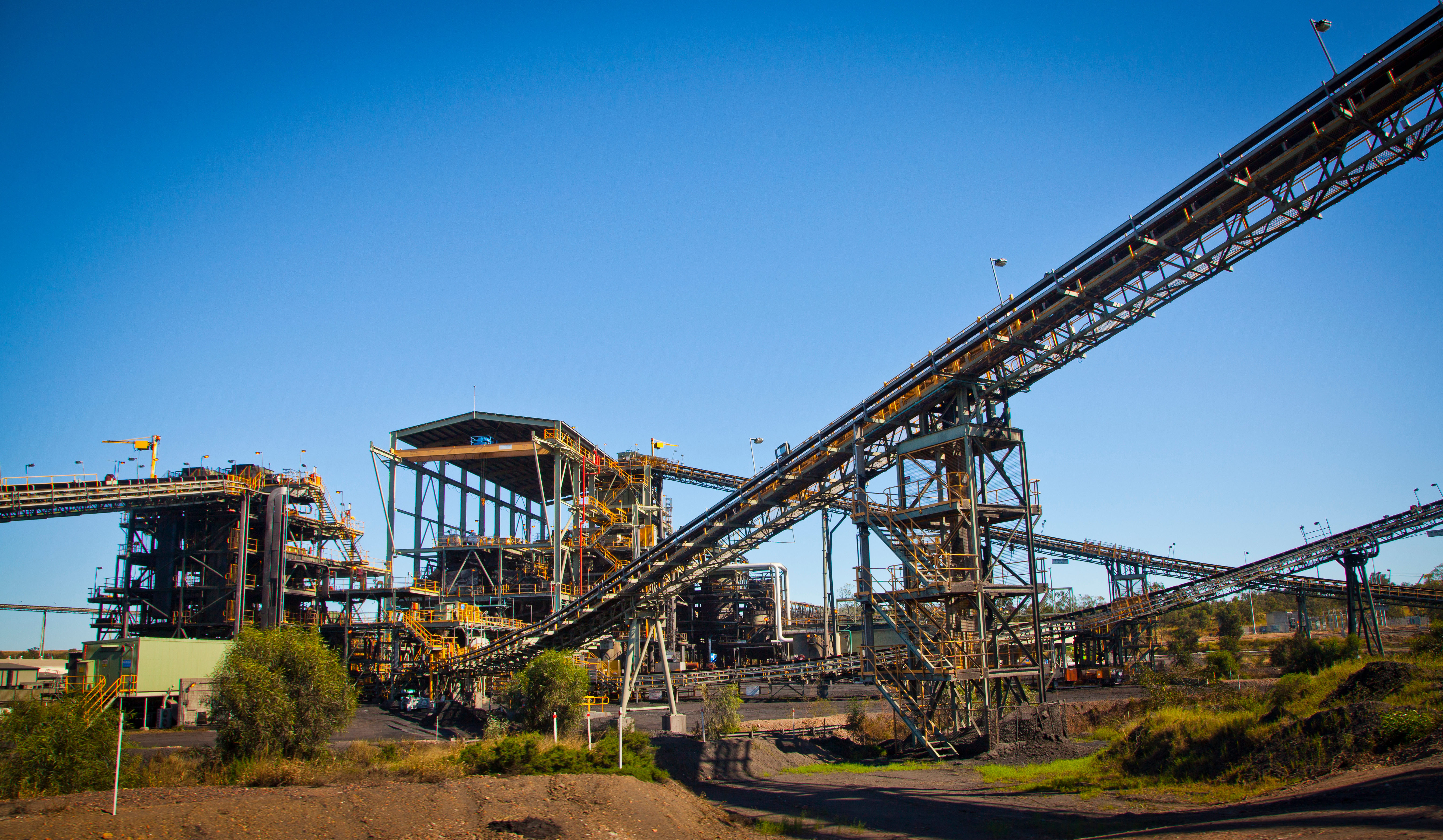 Mining site with conveyor systems, representing industries supported by LodgeLink workforce travel solutions.