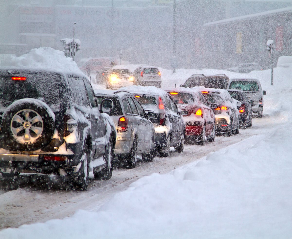 a traffic jam of cars on a snowy road.