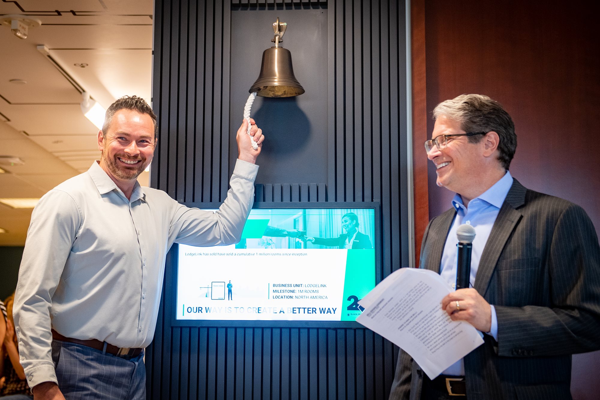 LodgeLink's VP, Commercial Sales & Supply ringing the bell.