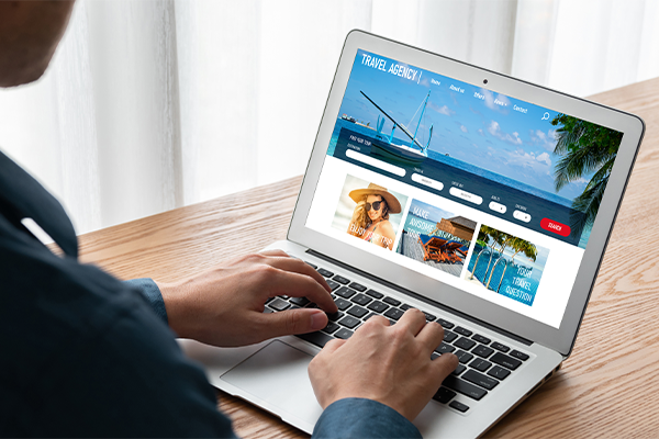 Person browsing a vacation booking website on a laptop.