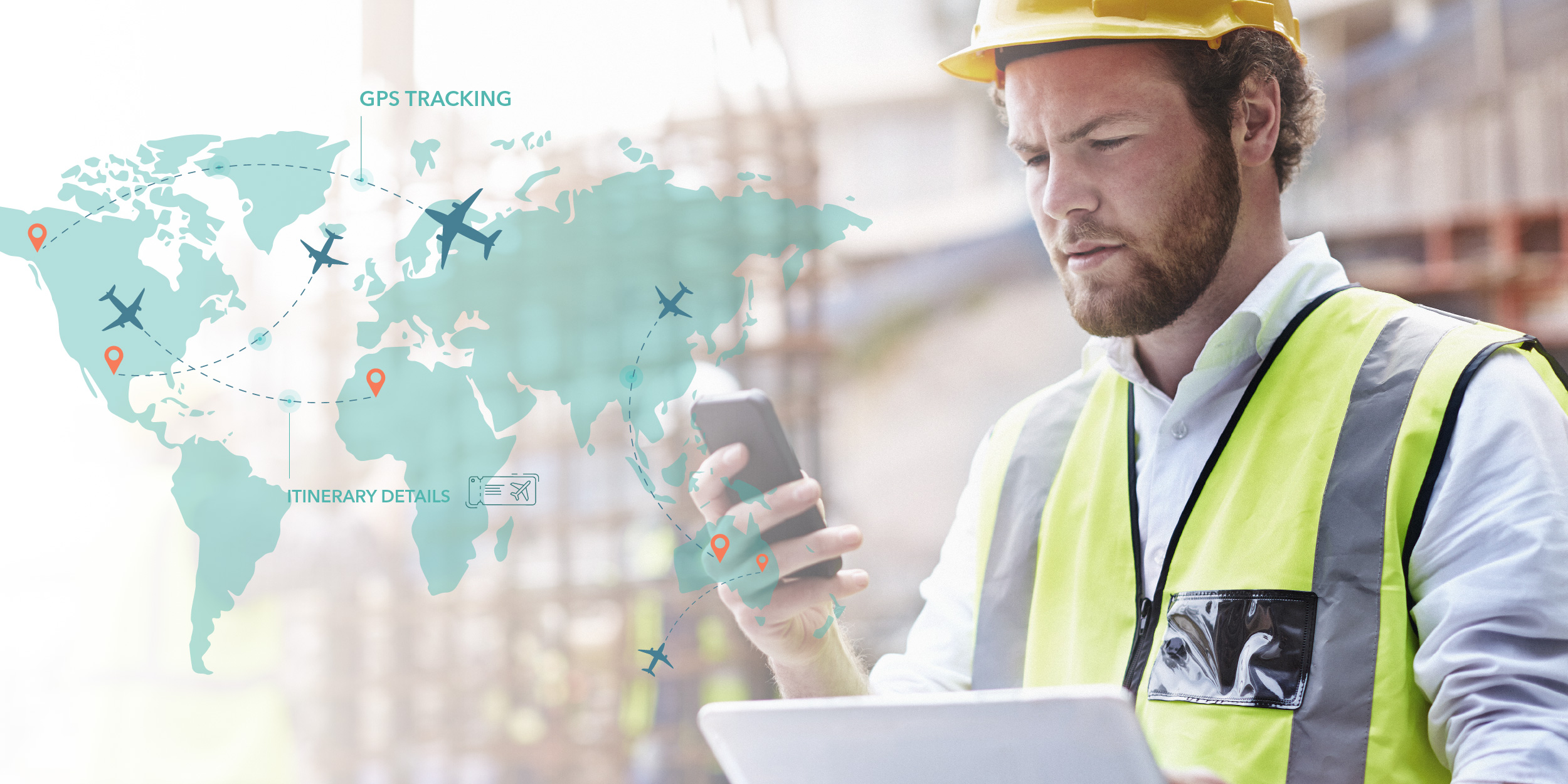 A man in a hard hat and safety vest uses a smartphone and laptop.