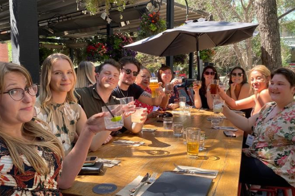 A group of colleagues sitting at a table enjoying drinks