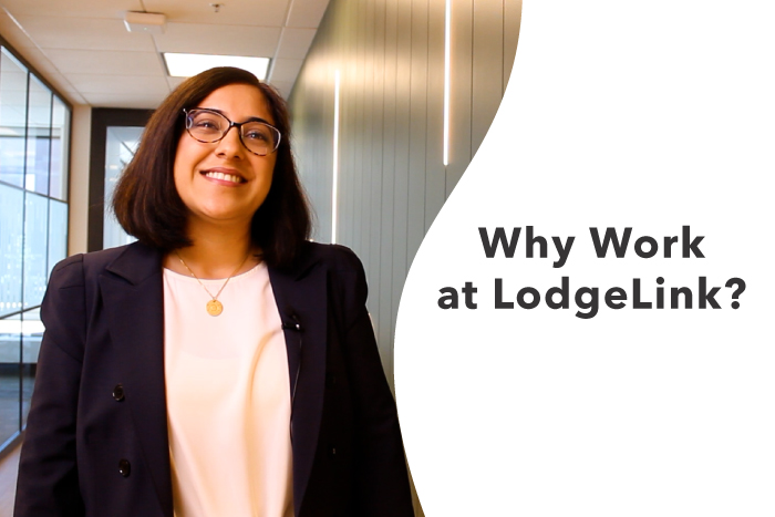 A person smiling in a hallway with the Why Work at LodgeLink Question beside them 