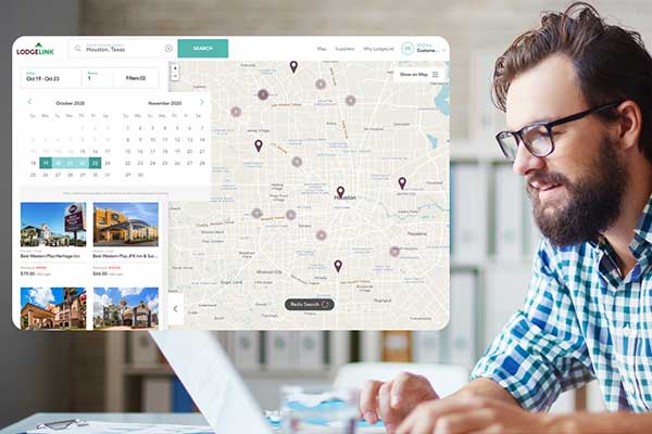 A person looking at a computer with a screenshot of LodgeLinks workforce travel site