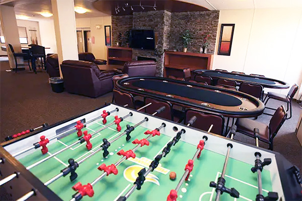 a foosball table in a living room inside of a lodge.