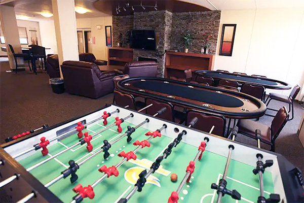 A foosball table in a living room inside of a lodge.