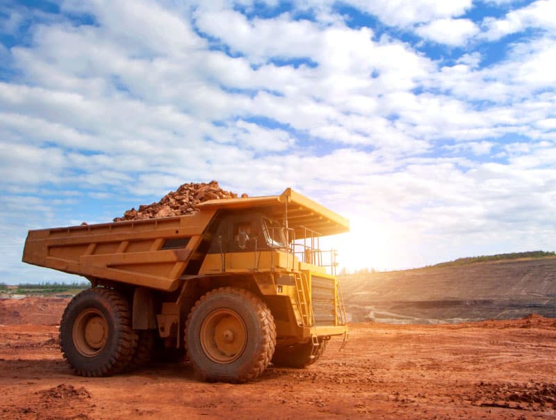 a dump truck in a coal mine representing declining mineral reserves and lack of infrastructure in the Canadian mining industry.