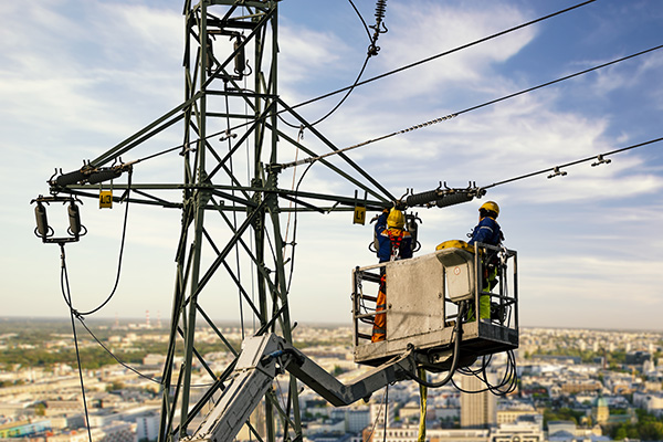 two men working on a power line.	